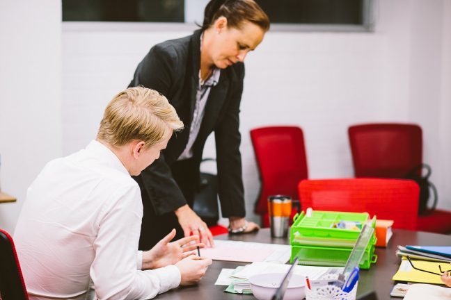 Two volunteer lawyers discuss a matter